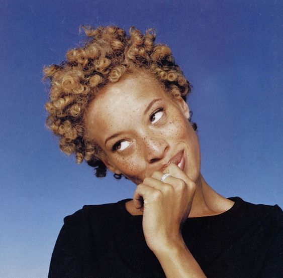 A black woman with short, blonde curls