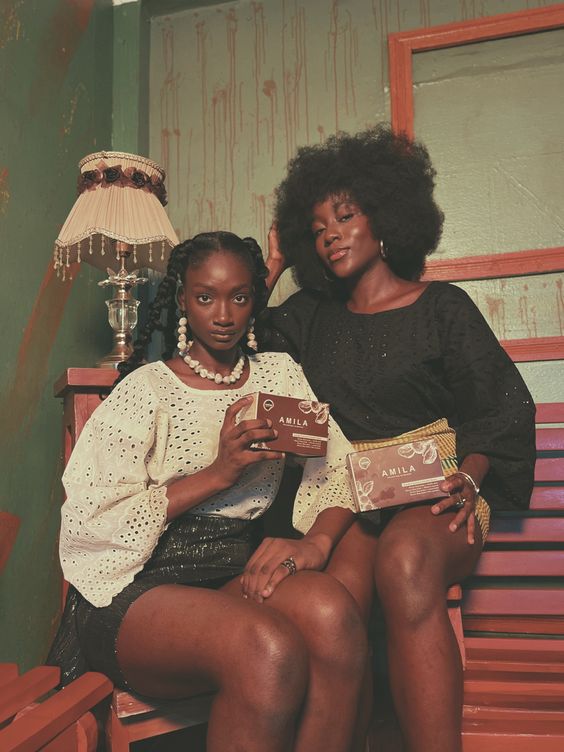 Two black girls posing, gazing intensely at the camera.